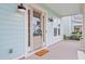 Inviting covered front porch with stylish lighting and a 'Welcome' doormat, enhancing the home's appeal at 1485 Bourne Xing, Mount Pleasant, SC 29466