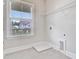 Practical laundry room with window view, shelving, and utility connections at 1485 Bourne Xing, Mount Pleasant, SC 29466
