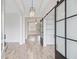 Bright living room with wood floors, modern lighting, and a stylish barn door, offering spacious living at 1485 Bourne Xing, Mount Pleasant, SC 29466