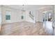 Bright living room showcasing wood floors, large windows, and access to a staircase at 1485 Bourne Xing, Mount Pleasant, SC 29466