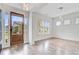 Airy, light-filled living area with wood floors, a wooden front door, and abundant natural light at 1485 Bourne Xing, Mount Pleasant, SC 29466