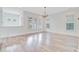 Bright living room with wood floors and large windows offers ample natural light at 1485 Bourne Xing, Mount Pleasant, SC 29466