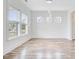 Bright living room with wood floors, white trim, ample natural light, and a minimalist design aesthetic at 1485 Bourne Xing, Mount Pleasant, SC 29466