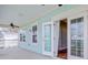 Inviting porch with aqua walls, ceiling fan, and French doors leading to the interior of the home at 1485 Bourne Xing, Mount Pleasant, SC 29466