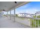 Spacious porch offering neighborhood views with white columns and railings on a sunny day at 1485 Bourne Xing, Mount Pleasant, SC 29466