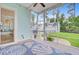 Screened porch with blue and white seashell rug with a seating area in the background at 1485 Bourne Xing, Mount Pleasant, SC 29466
