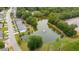 Aerial view of community pond surrounded by lush greenery, trees and townhomes at 1505 Blaze Ln, Charleston, SC 29412