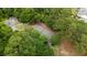 Aerial view of a tennis court surrounded by mature trees in a private residential community at 1505 Blaze Ln, Charleston, SC 29412
