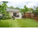 Serene backyard with artificial turf, a cozy patio, and mature trees creating a private outdoor space at 1505 Blaze Ln, Charleston, SC 29412