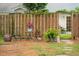 Inviting backyard with a wooden fence, cozy seating, and flourishing potted plants at 1505 Blaze Ln, Charleston, SC 29412