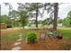 Picturesque backyard with a hammock, pond, and picnic table, creating a serene outdoor escape at 1505 Blaze Ln, Charleston, SC 29412