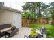 Cozy patio with seating and vibrant potted flowers, complemented by a well-maintained lawn and privacy fence at 1505 Blaze Ln, Charleston, SC 29412