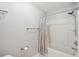 A tub-shower combination with gray shower curtain and brushed nickel hardware in a neutral bathroom at 1505 Blaze Ln, Charleston, SC 29412