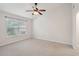 Bright bedroom with neutral carpet, a ceiling fan, and a window for natural light at 1505 Blaze Ln, Charleston, SC 29412