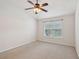 Clean bedroom with neutral carpet, a ceiling fan, and a large window for natural light at 1505 Blaze Ln, Charleston, SC 29412