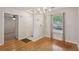 Dining area with a chandelier, hardwood floors, and a view of the front door at 1505 Blaze Ln, Charleston, SC 29412