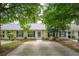 Charming townhouse featuring a well-maintained yard, quaint patio, and blue shutters at 1505 Blaze Ln, Charleston, SC 29412