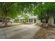 Charming townhouse featuring a well-maintained yard, quaint patio, and blue shutters at 1505 Blaze Ln, Charleston, SC 29412