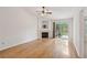 Open living space featuring a fireplace, ceiling fan, and access to the backyard at 1505 Blaze Ln, Charleston, SC 29412