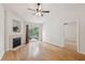 Cozy living room with fireplace, ceiling fan, and sliding glass doors to the backyard at 1505 Blaze Ln, Charleston, SC 29412