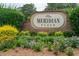 Welcoming 'Meridian Place' sign with brick base, flowers, and green shrubs at 1505 Blaze Ln, Charleston, SC 29412