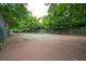 Outdoor tennis court with trees, showing the net and court markings in a well-maintained area at 1505 Blaze Ln, Charleston, SC 29412