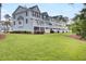 Backyard featuring well-manicured lawn and view of the townhome exterior at 1550 Spring Moss Rd, Mount Pleasant, SC 29466