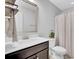 Cozy bathroom featuring vanity with sink and storage, toilet, mirror, light fixture, and a shower with a curtain at 1550 Spring Moss Rd, Mount Pleasant, SC 29466