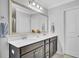 Bathroom with a double sink vanity, large mirror, neutral paint, and ample lighting above the sink at 1550 Spring Moss Rd, Mount Pleasant, SC 29466