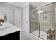 Bright bathroom featuring a glass shower, vanity with a modern sink, and neutral-toned tile flooring at 1550 Spring Moss Rd, Mount Pleasant, SC 29466