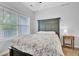 Bedroom featuring a green bedframe, white bedding, a window with blinds, and a wooden side table at 1550 Spring Moss Rd, Mount Pleasant, SC 29466