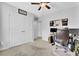 Bright bedroom featuring neutral walls, plush carpeting, closet, ceiling fan, and an organized work space at 1550 Spring Moss Rd, Mount Pleasant, SC 29466