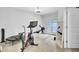Home gym with a Peloton bike, rowing machine, and ample workout space near the French doors at 1550 Spring Moss Rd, Mount Pleasant, SC 29466