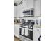 Bright kitchen featuring stainless steel oven/microwave and sleek white cabinets at 1550 Spring Moss Rd, Mount Pleasant, SC 29466