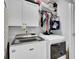 Efficient laundry room with white cabinetry, modern washer and dryer, and organized storage solutions at 1550 Spring Moss Rd, Mount Pleasant, SC 29466