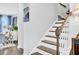Bright staircase with hardwood steps, white risers, and painted walls at 1550 Spring Moss Rd, Mount Pleasant, SC 29466