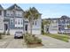 Exterior shot of townhomes with neat landscaping, driveways, and modern architectural details at 1550 Spring Moss Rd, Mount Pleasant, SC 29466