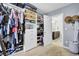 Organized walk-in closet with custom shelving, adjacent to a bathroom, offering an open and airy feel at 1550 Spring Moss Rd, Mount Pleasant, SC 29466