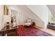 Hallway with hardwood floors and a sloped ceiling with a reading chair, desk, and accent rug at 1612 John Fenwick Ln, Johns Island, SC 29455