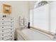 Bright bathroom featuring a soaking tub, large window, and a classic vanity with ample storage space at 1612 John Fenwick Ln, Johns Island, SC 29455