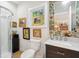 Bright bathroom featuring a glass shower, artistic decor, and floral wallpaper surrounding the mirror at 1612 John Fenwick Ln, Johns Island, SC 29455