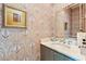 Stylish powder room has patterned wallpaper, and a marble vanity with modern fixtures at 1612 John Fenwick Ln, Johns Island, SC 29455