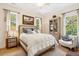 Comfortable bedroom featuring two windows, stylish decor, and a cozy bed with decorative pillows and blankets at 1612 John Fenwick Ln, Johns Island, SC 29455