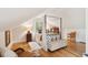 Cozy bedroom featuring a four-poster bed, hardwood floors, and natural light streaming through the window at 1612 John Fenwick Ln, Johns Island, SC 29455