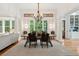 Formal dining room features elegant lighting, ample seating, and windows, perfect for hosting gatherings and dinners at 1612 John Fenwick Ln, Johns Island, SC 29455