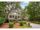 Charming two-story home with landscaped yard and inviting front porch, exuding Southern charm and curb appeal at 1612 John Fenwick Ln, Johns Island, SC 29455