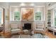 Cozy living room showcasing a fireplace, custom built-ins, and ample natural light for a comfortable ambiance at 1612 John Fenwick Ln, Johns Island, SC 29455