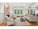 Bright living room features a fireplace, large windows, and comfortable seating, perfect for relaxation and entertaining at 1612 John Fenwick Ln, Johns Island, SC 29455