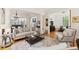 Open-concept living space featuring hardwood floors and large windows, connecting seamlessly with other living areas at 1612 John Fenwick Ln, Johns Island, SC 29455
