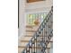 Staircase with wood treads and decorative iron railings at 1612 John Fenwick Ln, Johns Island, SC 29455